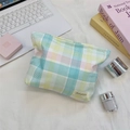 Detail of macaron plaid fabric cosmetic bag with brand woven label on white desk - Large Plaid Stripe Green