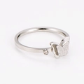 Macro detail of silver butterfly ring with sparkling wings and single zircon inlay - US 6 / Steel