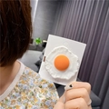 Detail of creative poached egg hair clip showing realistic food texture on card - Egg