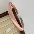Detail of champagne pink sponge headband with satin texture on a wooden tray - Snow Bud Pink