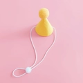 Detail of yellow felt pet birthday party hat with adjustable elastic strap and soft pompom - Yellow Birthday Hat
