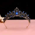 Detail of baroque crown featuring blue teardrop stones and black crystals on bronze metal - No.1 Antique Gold (Royal Blue Stone)