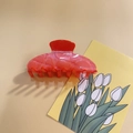 Detailed view of large red translucent resin hair claw clip with glitter finish - Orange Red