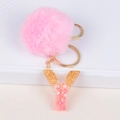 Detailed shot of pink faux fur pompom and resin letter Y keychain with gold flakes - Letter Y