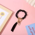 Chic black matte resin chain keychain with golden metal ring and black fringe tassel - Black