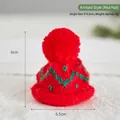 Mini red knitted Christmas hat with green pattern for festive doll decorations - Knitted Red Hat