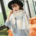 Plaid winter scarf in beige and light blue with fringe tassels on model - Small Grid Milan