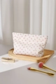 Detailed close-up of floral makeup bag with H & R label on a wooden texture background - Pink Floral (Large)