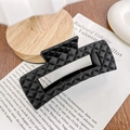 Glossy black quilted hair claw clip with lattice pattern on a vintage newspaper background - 10.5cm / Black