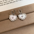 Macro shot of heart-shaped silver earrings with mother of pearl and zircon inlay - 14# Silver Heart Pendant Shell Ear Cuff