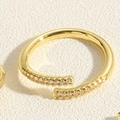 Detail of 14K gold plated bamboo design ring featuring micro-pave cubic zirconia accents - Micro-set Crossed Design