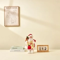 Standing Santa Claus figurine in red and gold sequin robe holding a gold bell and gift bag - 30cm