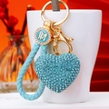 Blue rhinestone heart keychain with gold hardware and braided rope detail close-up - Sky Blue Fortune Rope + Blue Heart