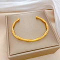 Minimalist bamboo-style gold titanium steel open bangle displayed on a luxury jewelry box - Gold (P317)