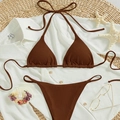 Dark brown ribbed bikini set with halter top and side-tie bottoms on summer beach props - Red Brown