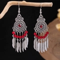 Detail of bohemian red fringe earrings hanging on a branch with a dark background - Antique Silver + Red Beads + Feather Tassel (E5775-25/Antique Silver)