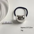 Black elastic hair tie with silver hammered metal bean charm measuring 3.5x2.5cm - Short Oval Silver