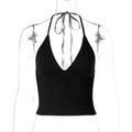 Detail of black halter neck crop top with deep V-neck on a transparent mannequin - S / Black