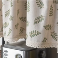 Detailed close-up of white cotton cafe curtain with green leaf prints and lace trim - 150x45cm / Olive Leaf Hook Style Tier
