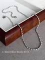 Detailed macro view of a silver rice bead chain necklace with adjustable extender link - Style 3: Silver Beaded Chain 41+5cm