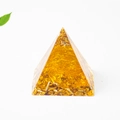 Golden resin crystal pyramid with gold foil and natural stones on white background - 3cm / Citrine