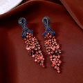Macro shot of vintage bow tassel earrings with red and blue zircon stones on velvet fabric - Silver Pin-Blue-Red