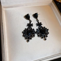 Macro shot of gothic black heart earrings with set stones in a jewelry box - Silver Earring Post-Black