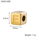 Detailed macro of gold titanium cube bead with letter E engraving, size 0.5cm x 0.5cm - Letter E / Gold