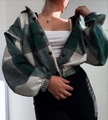 Close-up of green plaid flannel jacket featuring button closure and lantern sleeves - S / Green