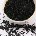 DIY 2mm black glass seed beads in a white ceramic bowl for handmade jewelry crafting - Black
