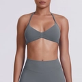 Detailed view of the seamless ribbed fabric and V-neck halter sports bra construction - Dark Gray