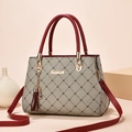 Elegant beige diamond pattern tote with deep red handles and stylish tassel detail - Light Maple & Wine Red