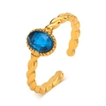 Gedrehter goldener Titanstahlring mit einem funkelnden ovalen blauen Zirkonstein - US 7 / Blauer Zirkon
