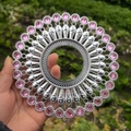 Close-up of silver metal wall decor with pink rhinestones and hollow center design - Bright Silver Light Purple
