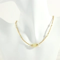 Close-up of beaded necklace with gold metal beads and translucent light green stones - New Mountain Jade (NE1991)