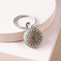 Macro shot of mandala pattern glass dome on a vintage bronze metal keychain - Style 7