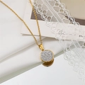 Close-up of gold-plated titanium necklace with round pavé-set crystal pendant on mirror - Full Pave Circle