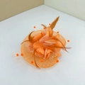 Elegant orange fascinator hat with feathers, flowers and mesh veil for weddings - With Alligator Clip / Orange