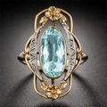 Vintage gold ring with oval blue gemstone and intricate floral engravings for women - US 7 / Gold & Silver