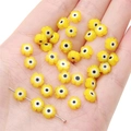 Yellow flower glass beads with evil eye design for DIY jewelry making and craft projects - Yellow