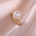 Golden sunflower ring with sparkling zircon petals on a soft pink silk background - Adjustable Open / Rotating Sunflower Ring