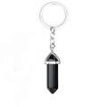 Detail view of a black onyx hexagonal prism pendant on a silver metal keychain - Black Agate