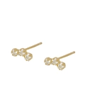 Close-up of minimalist gold-tone stud earrings featuring three curved cubic zirconia stones - Arc 3-Stone Studs-Gold
