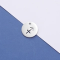 Macro detail of silver stainless steel Sagittarius constellation cutout charm pendant - Sagittarius