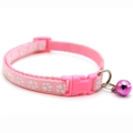 Detailed view of pink nylon pet collar with white paw prints, buckle and silver bell - JY Paw Print / Pink