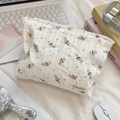 Detailed close-up of floral toiletry bag with lace texture and brand tag on desk - Pink Rose Jacquard