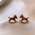 Detailed macro view of 18K gold-plated pony stud earrings on luxurious champagne silk fabric - Textured Horse (28#)