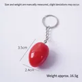 Red egg-shaped keychain charm with marble texture effect and silver ring, 3.5cm x 2.4cm - Oval-shaped Whole Red Cherry Tomato (keychain)