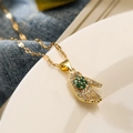 Gold palm pendant necklace with green clover stone and zircon on a white plate - Gold with Green Gemstone