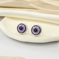 Detail of purple glitter resin evil eye studs on a minimalist off-white tray with silk - Silver Purple Glitter Eye